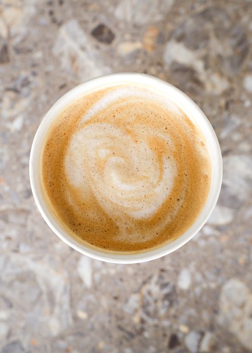 Hot latte in mug sitting on countertop